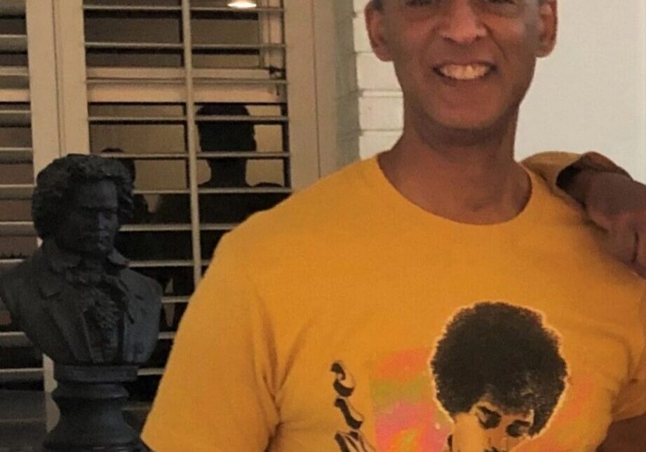 Smiling man with statue in background