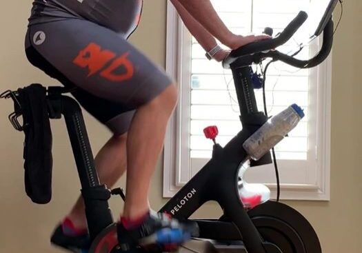 Man cycling on exercise bike indoors